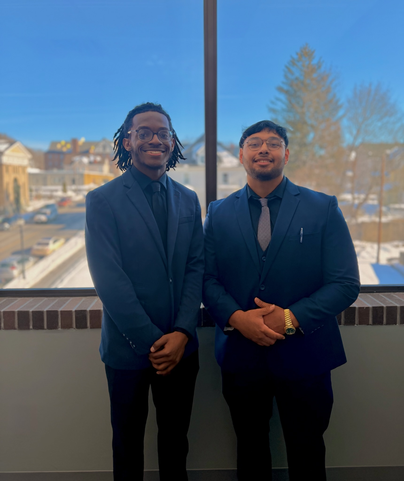Two Skyline Consulting professionals standing by a window